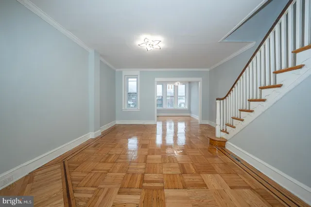 a view of entryway and hall with wooden floor