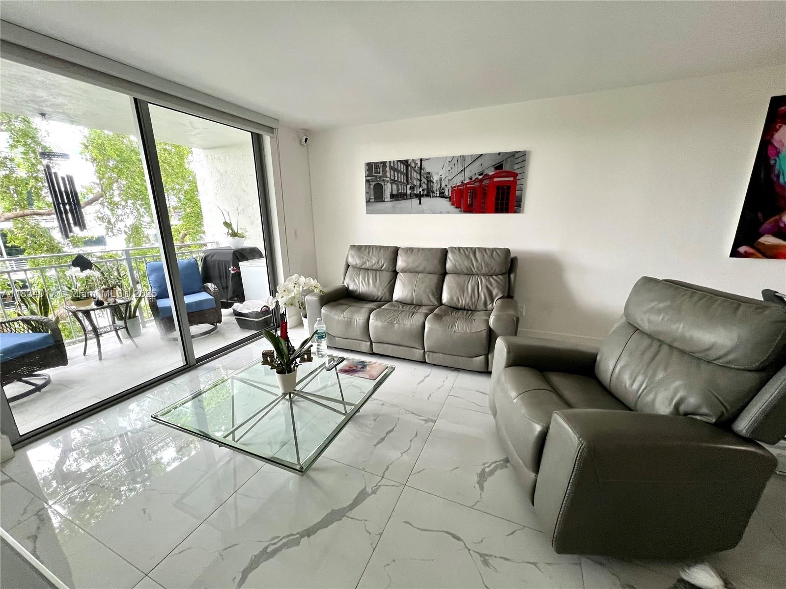 680 Northeast 64th Street, Unit A501 Miami, FL 33138 - Photo 14 of 30 a living room with furniture and a large window