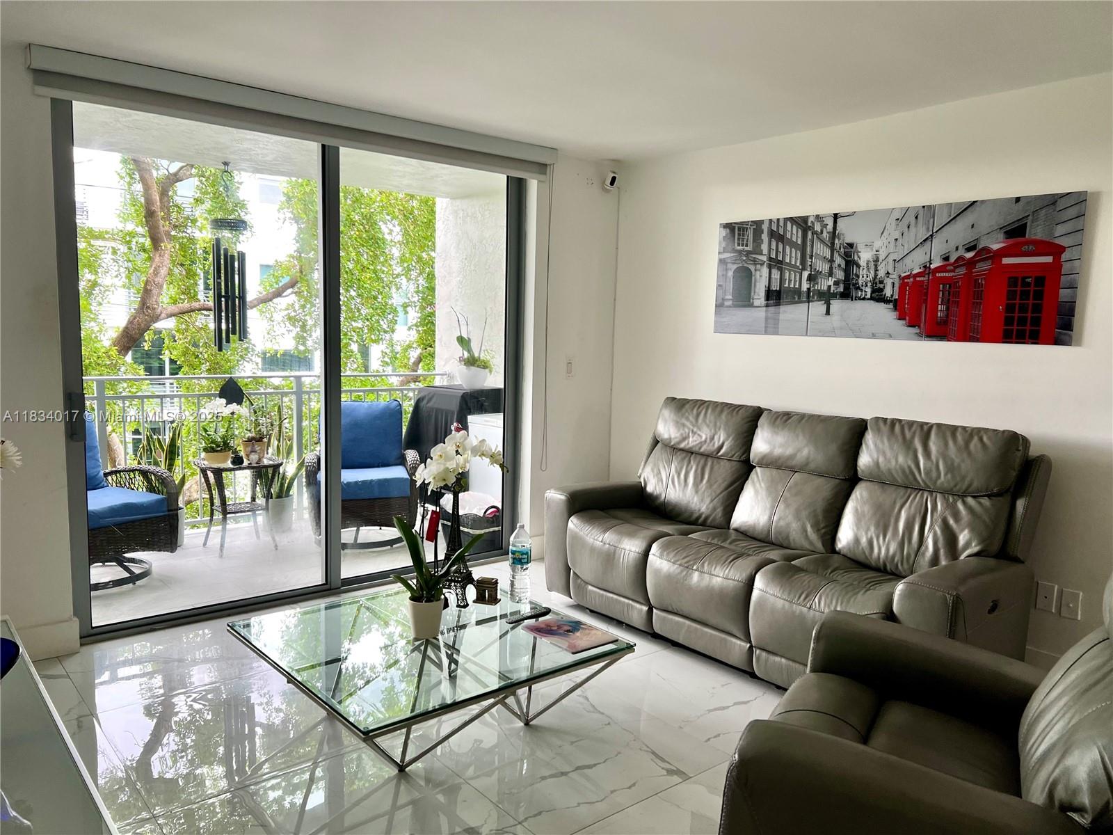 680 Northeast 64th Street, Unit A501 Miami, FL 33138 - Photo 15 of 30 a living room with furniture and a large window