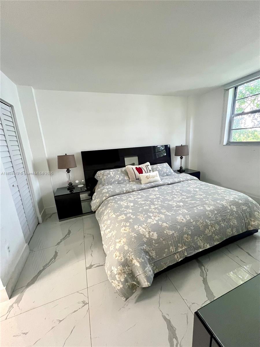 680 Northeast 64th Street, Unit A501 Miami, FL 33138 - Photo 16 of 30 a bedroom with a bed and window