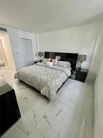 a bathroom with a sink mirror and toilet