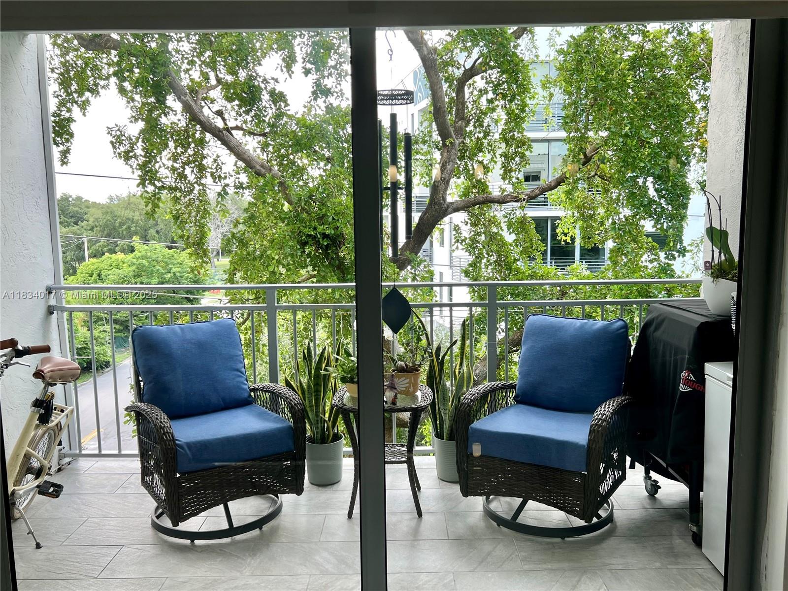 680 Northeast 64th Street, Unit A501 Miami, FL 33138 - Photo 19 of 30 a bench sitting in a park with large trees