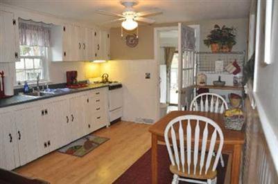 12 Colony Road Dennis Port, MA 02639 - Photo 3 of 12 a kitchen with stainless steel appliances granite countertop a sink a stove and a refrigerator