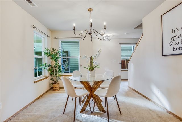 a view of a dining room with furniture and front door