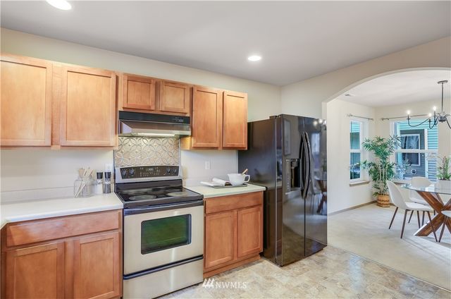 a kitchen with a stove a sink and a refrigerator