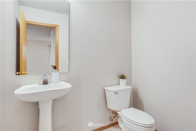 a bathroom with a sink toilet and mirror