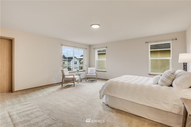 a bedroom with a bed a table and chair