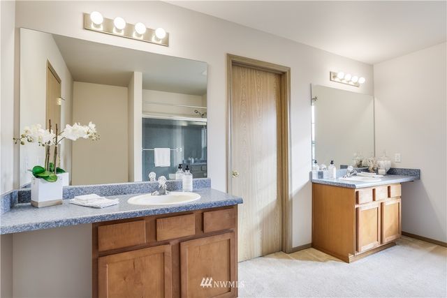 a bathroom with a double vanity sink and a mirror