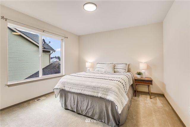 a bedroom with a bed and window