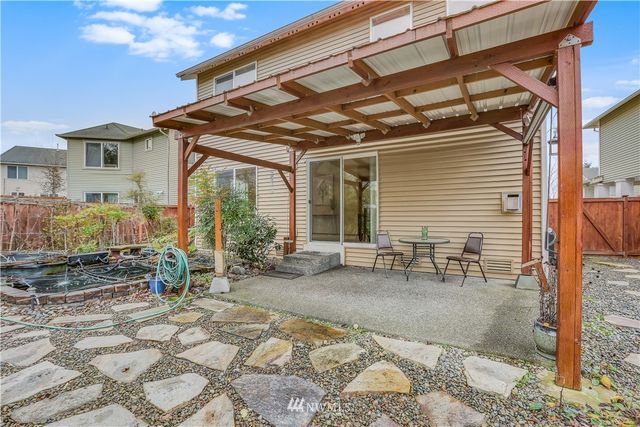 a view of a backyard with sitting area