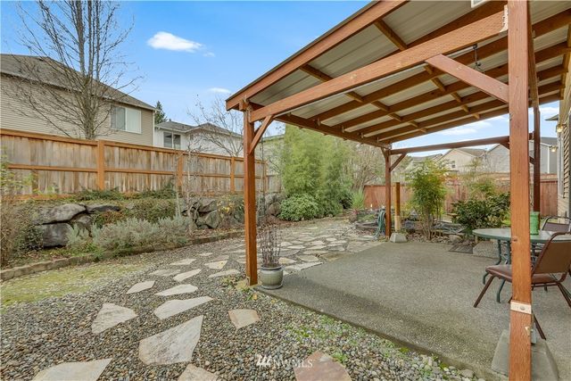 a backyard of a house with a large tree