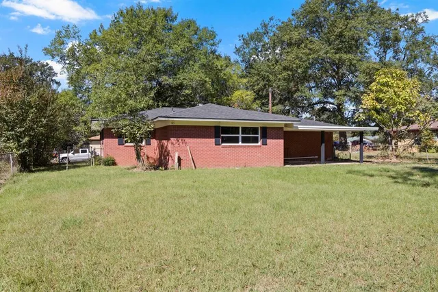 a view of a house with a backyard patio and swimming pool