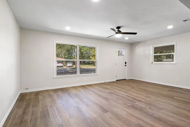 wooden floor in an empty room with a window