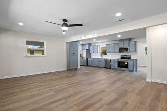 a view of a kitchen with a sink and a window