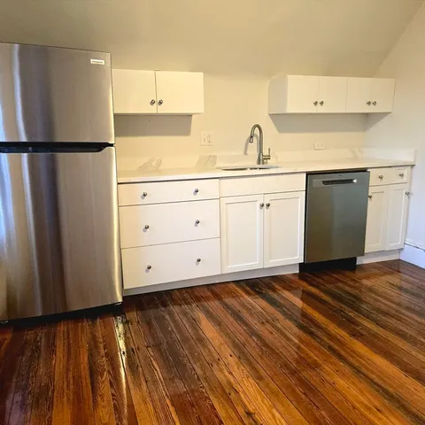 a kitchen with stainless steel appliances a refrigerator sink and cabinets
