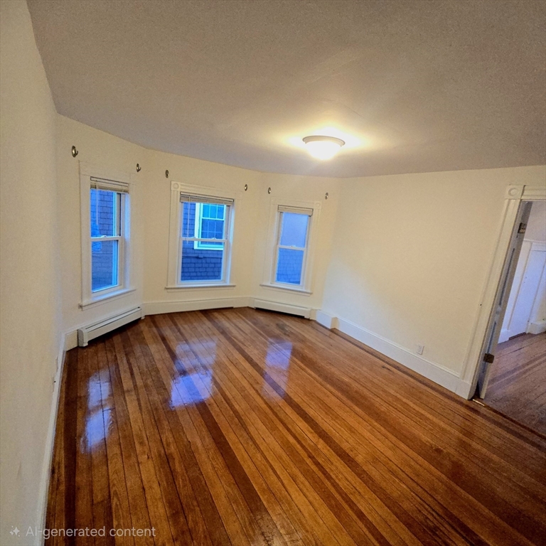 94 Morrison Avenue, Unit 3 Somerville, MA 02144 - Photo 5 of 12 wooden floor in an empty room with a window