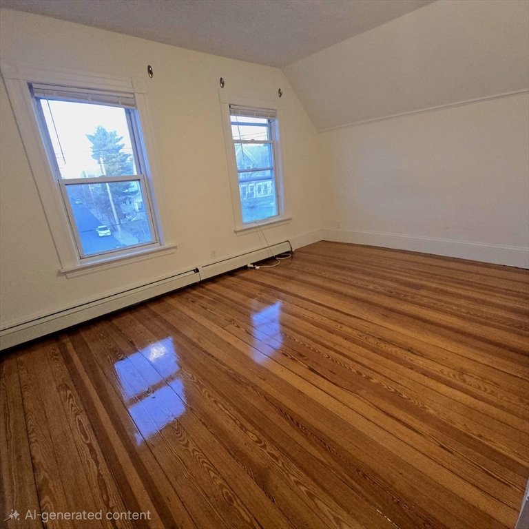 94 Morrison Avenue, Unit 3 Somerville, MA 02144 - Photo 7 of 12 an empty room with wooden floor and windows