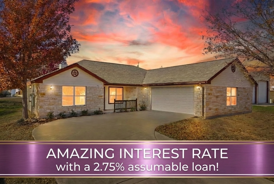 View of front of home with concrete driveway, roof with shingles, a garage, and stone siding