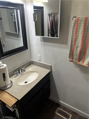 a bathroom with a sink vanity and mirror
