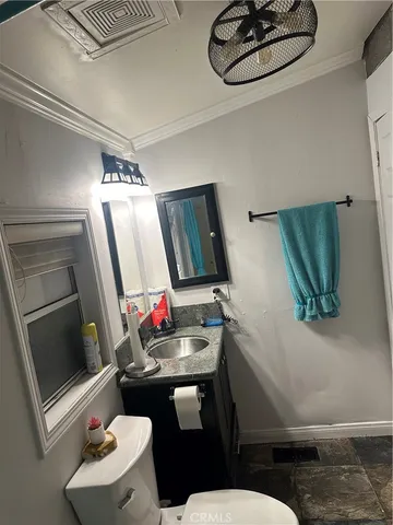 a bathroom with a sink mirror vanity and toilet