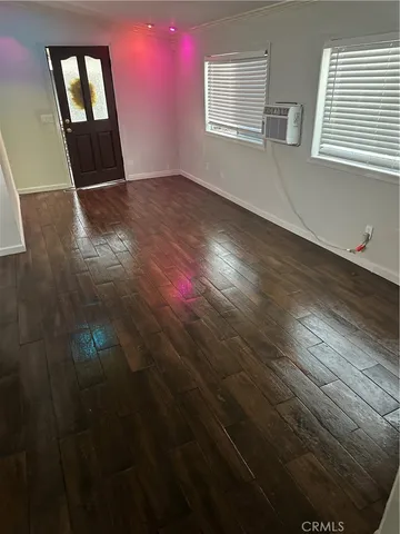 a view of empty room with window and fireplace
