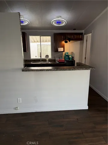 a view of a room with wooden floor and window