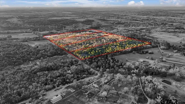 a view of a dry yard with wooden fence