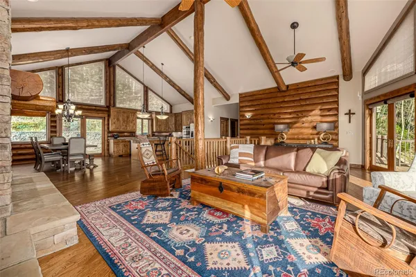 a dining room with furniture entryway and wooden floor