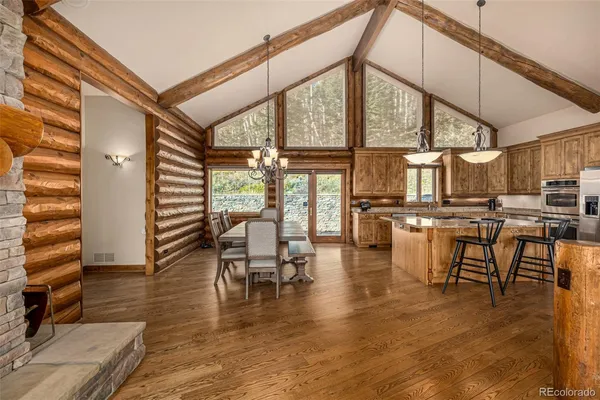 a kitchen with stainless steel appliances granite countertop a stove and large wooden cabinets