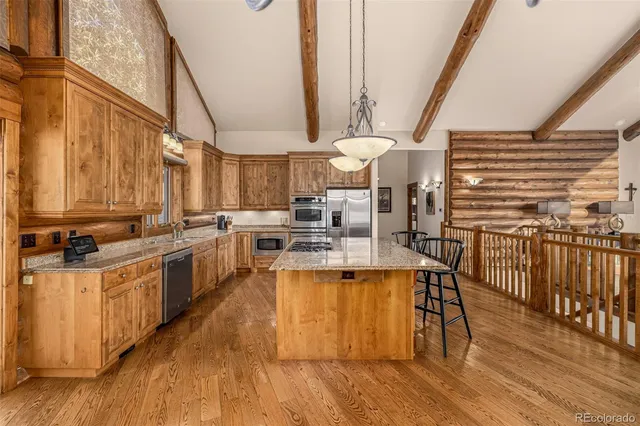a kitchen with granite countertop a sink and cabinets