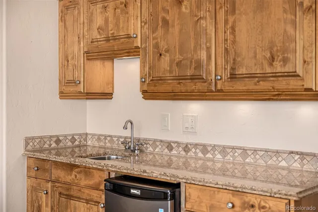 a kitchen with stainless steel appliances granite countertop a stove a refrigerator and a microwave