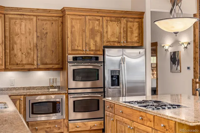 a bathroom with a granite countertop sink and a large mirror