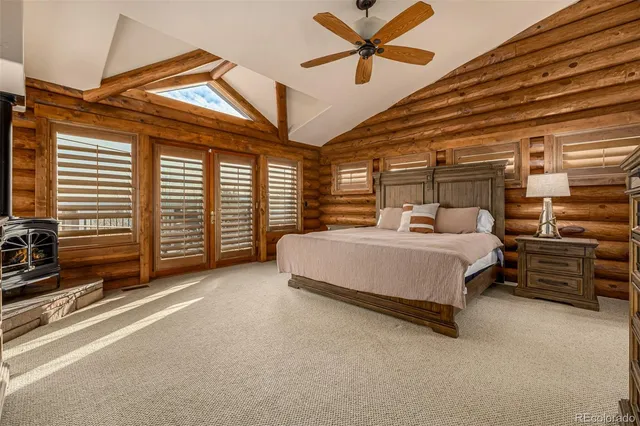 a bedroom with a bed a flat screen tv and dresser