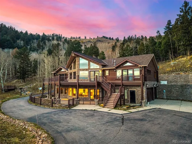a front view of a house with a yard and balcony