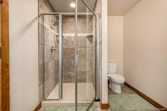 a bathroom with a granite countertop sink toilet mirror and a bathtub