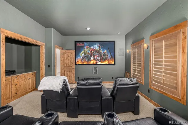 a kitchen with stainless steel appliances granite countertop a refrigerator a stove and a sink with cabinets