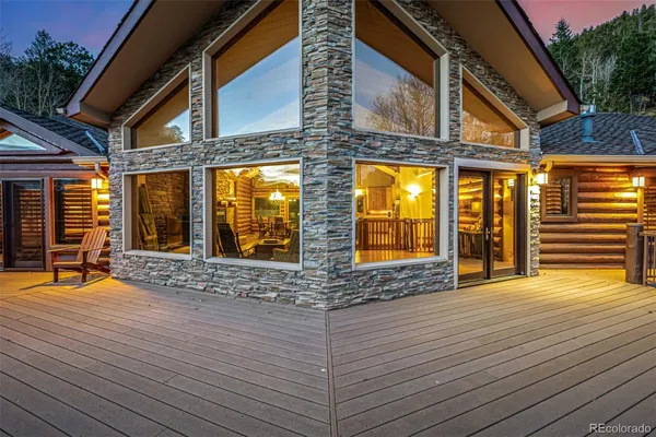 a living room with furniture a large window and a fireplace