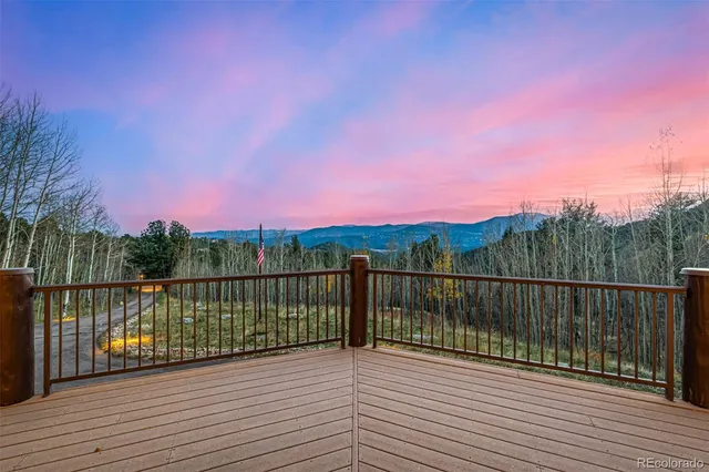 a living room with furniture a large window and a fireplace