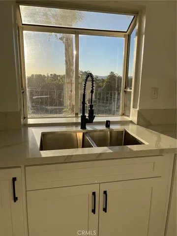 a view of empty room with wooden floor and fireplace