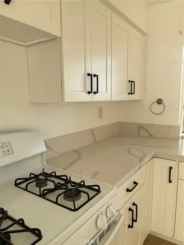 a white stove top oven sitting inside of a kitchen