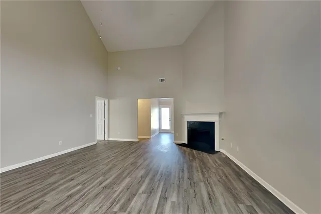 a view of a livingroom with wooden floor and a fireplace