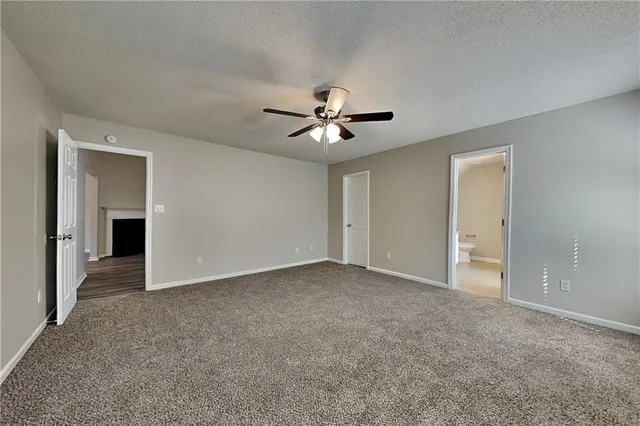 a view of an empty room with a ceiling fan