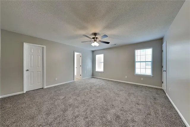 a view of an empty room with a ceiling fan