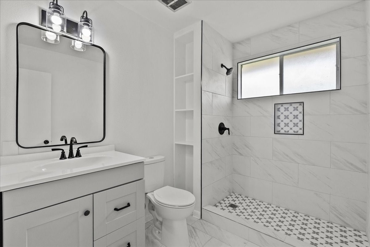 5762 Birdwood Road Houston, TX 77096 - Photo 35 of 50 MODERN GEOMETRIC TILING ACCENT THIS UPDATED FULL BATH IN THE MOTHER-IN-LAW SUITE.