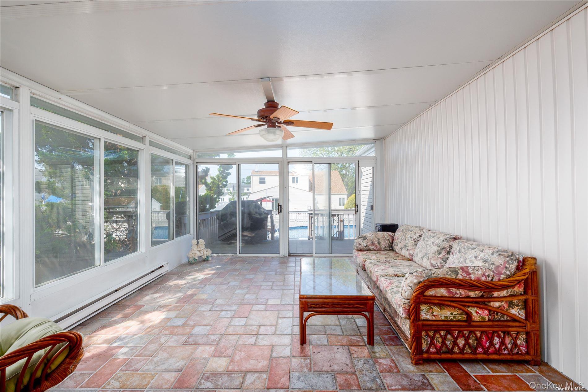 3418 Oceanside Road Oceanside, NY 11572 - Photo 11 of 29 a living room with furniture fireplace and large windows