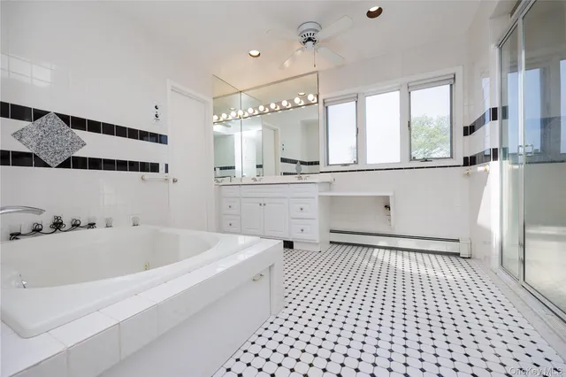 a bathroom with a sink a toilet a mirror and shower