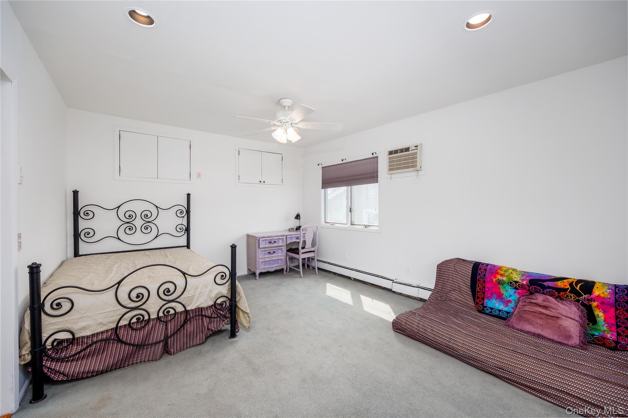 3418 Oceanside Road Oceanside, NY 11572 - Photo 23 of 29 a bedroom with furniture and a chandelier