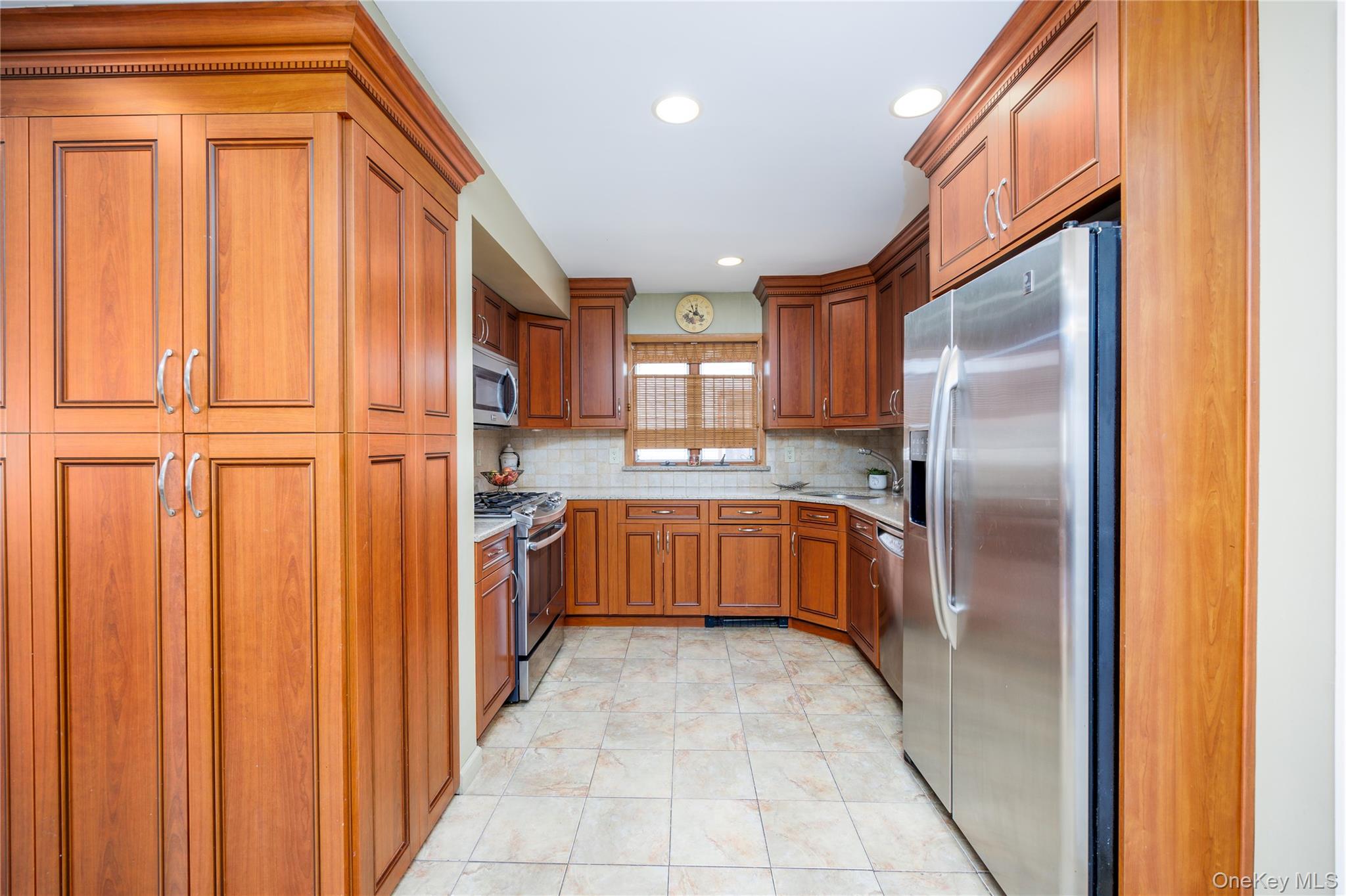 3418 Oceanside Road Oceanside, NY 11572 - Photo 4 of 29 a kitchen with stainless steel appliances granite countertop a refrigerator and a sink