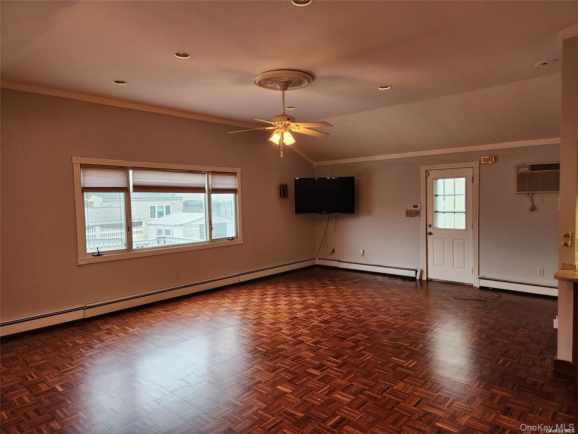 3418 Oceanside Road Oceanside, NY 11572 - Photo 9 of 29 an empty room with wooden floor and windows
