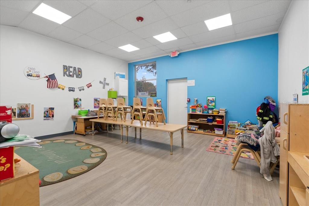 1938 Northeast Waldo Road Gainesville, FL 32609 - Photo 12 of 64 a living room with furniture and a wooden floor